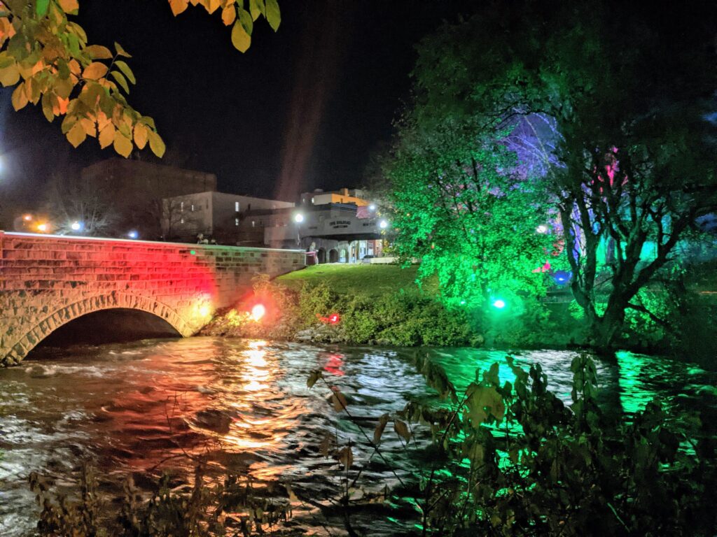 Photo of Jamestown Riverwalk illuminated with colorful lights
