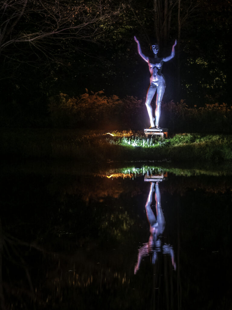 Female sculpture illuminated with LED lights