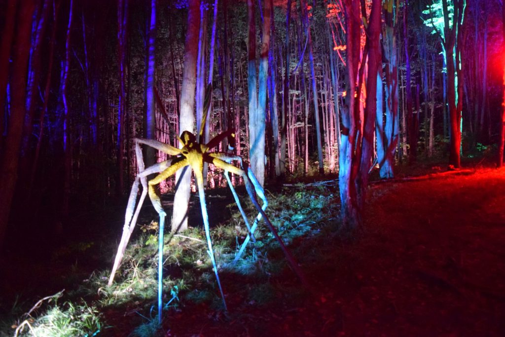 sculpture of giant mosquito illuminated in LED lights at sculpture park